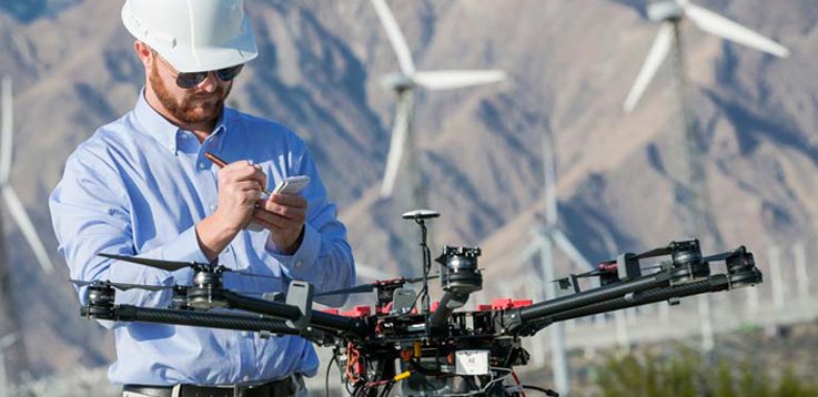 Image of UAV in front of a wind turbine